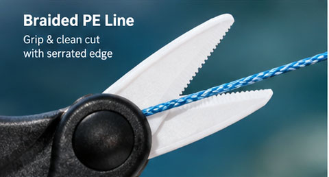 Close-up of ceramic fishing scissors cutting braided PE fishing line