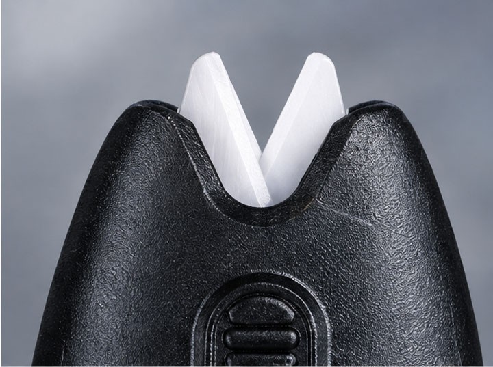 Close-up of white zirconia ceramic blades on black fishing scissors