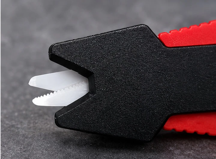 Close-up of a ceramic fishing line cutter blade showing the serrated edge on one side